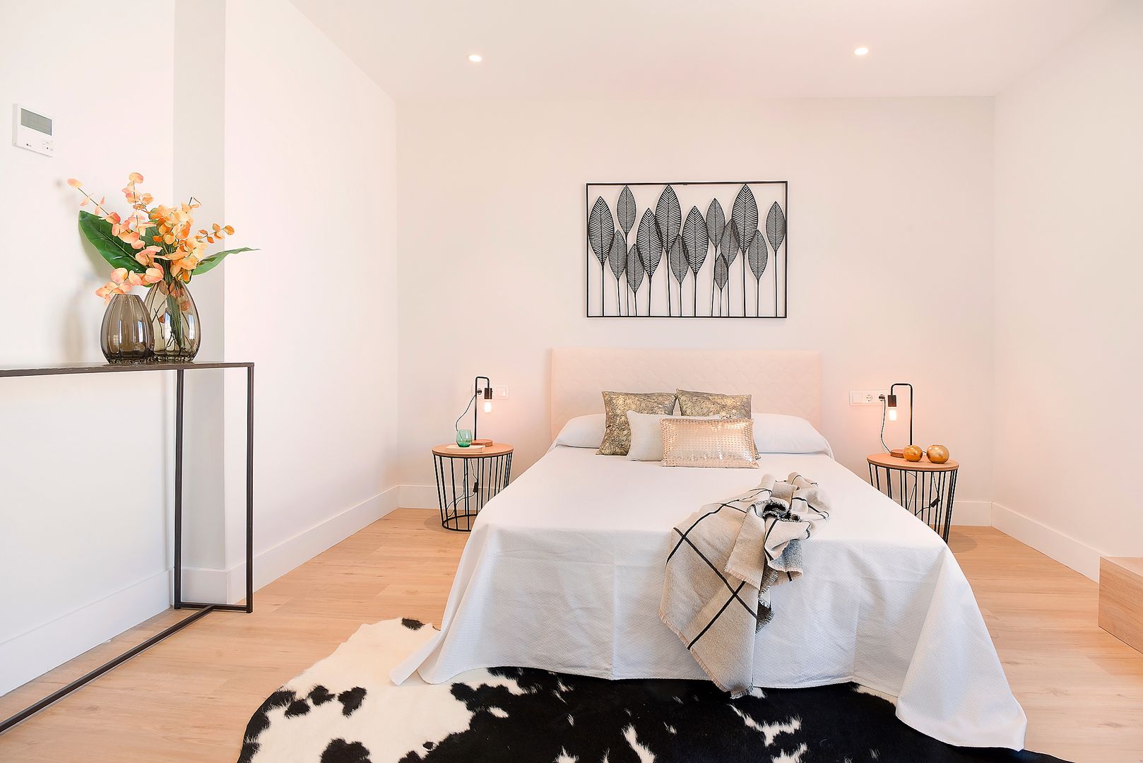 Master bedroom Markham Stagers Modern Bedroom home staging,minimal,black and white,rug,cow rug,iron,artwork,throw,leather