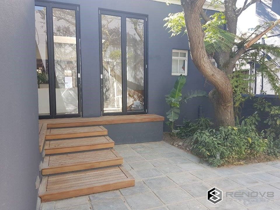 Completion - Exterior Courtyard: modern by Renov8 CONSTRUCTION, Modern wooden stairs,decking,exteerior walls,paint,plaster,modern design,glass doors,heritage site,renovation,restoration,refurbishment,commercial construct