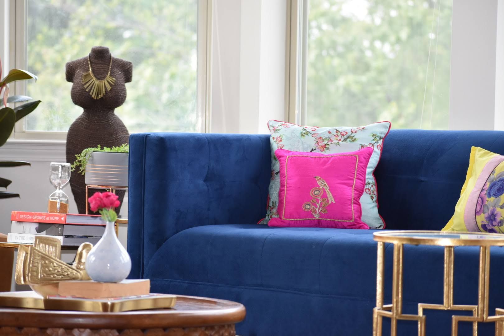 Beautiful Vignette of a decorative mannequin & blue velvet sofa Spaces Of Hue Eclectic style living room Textile Amber/Gold Sofas & armchairs