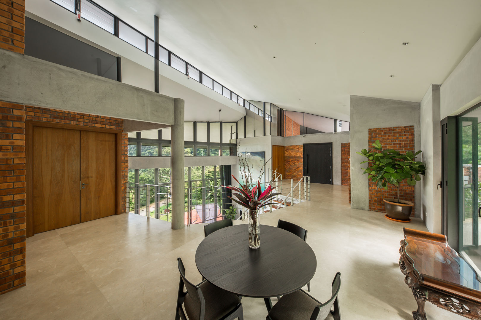 Upstairs pantry space overlooking the atrium MJ Kanny Architect Tropical style living room