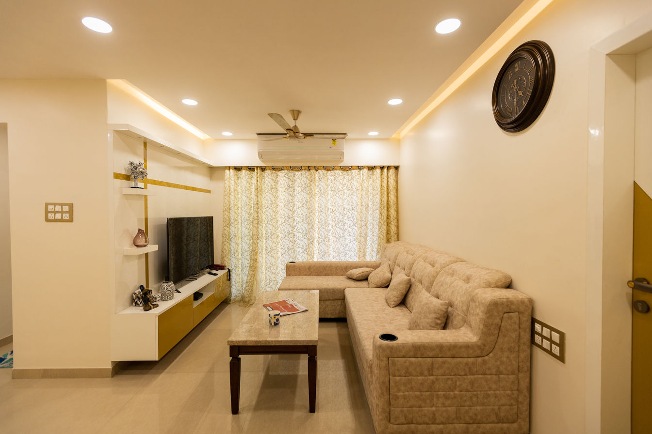 The Golden Touch The 7th Corner Interior Modern living room Plywood interior design, interior, interior designer in mumbai, luxury interior, interior designer, home interior, residential interior, luxury interior designer, ac pelmet, beige, ceiling, centre table, colour, curtain, design, door, fan , gold,indirect light,ledge,lights,living area,living room design,paint, planning, sofas, strip light, tv unit, mandir design