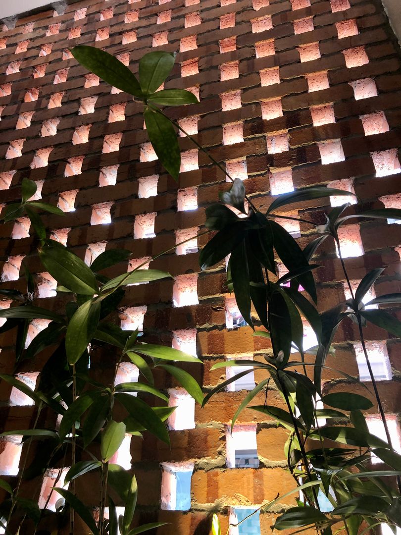 Red bricks design is carried into the interior with the japanese bamboos planted N O T Architecture Sdn Bhd Walls