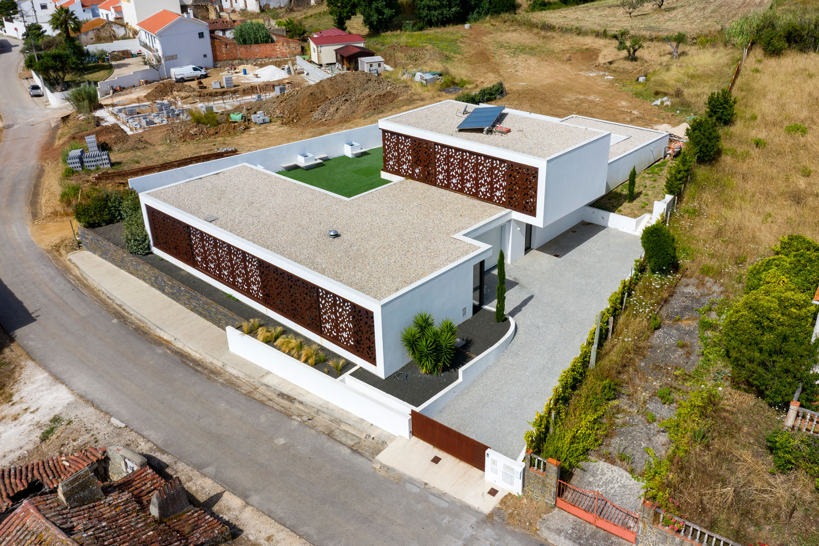 Aerial View of the Villa Pascal Millasseau Construction Single family home aerial view drone house steel corten floral solar panels entry garage perspective villa high-end modern elegant