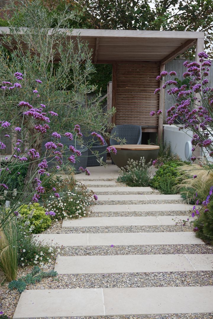 Mediterranean gravel garden with plank paving leading to a pergola Fern and Pine Garden Designers and Landscape Architects Mediterranean style garden mediterranean garden, modern garden design, contemporary garden, modern garden ideas, terraced garden ideas, architectural garden design, brighton garden, garden design, contemporary garden design, garden designer, garden designers near me, local garden designers, contemporary garden ideas, garden design hove, garden architect, garden design sussex, small garden design, contemporary garden design ideas, gravel garden, olive tree, pergola, iroko timber, verbena, plants